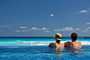 Casal apreciando a vista de Cancun a partir da piscina do resort